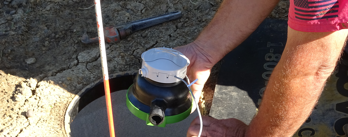 A maintenance worker installing a new water meter.